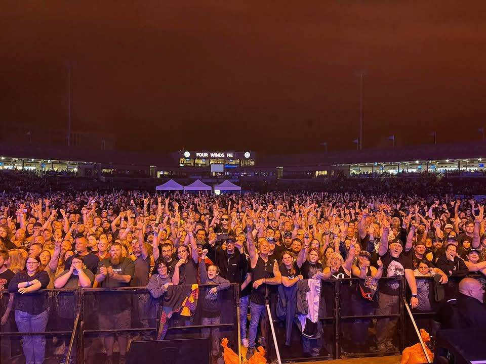 Concert crowd with hands raised at Four Winds Field